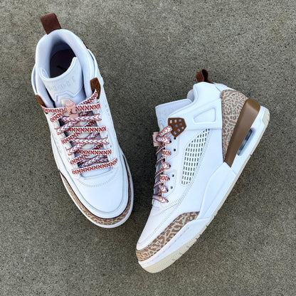 jordan spizikes with white nesia shoelaces with brown spear pattern on cement background