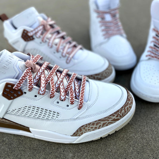 jordan spizikes with white nesia shoelaces with brown spear pattern on cement carpark background