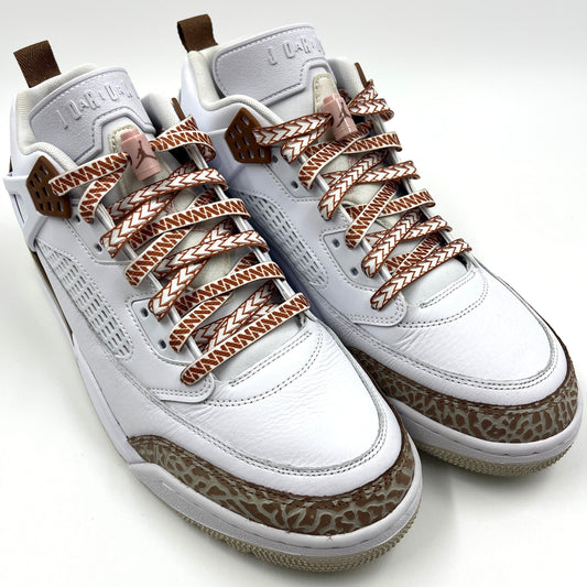 Jordan spizikes with white nesia shoelaces with brown spear patterns on white studio background