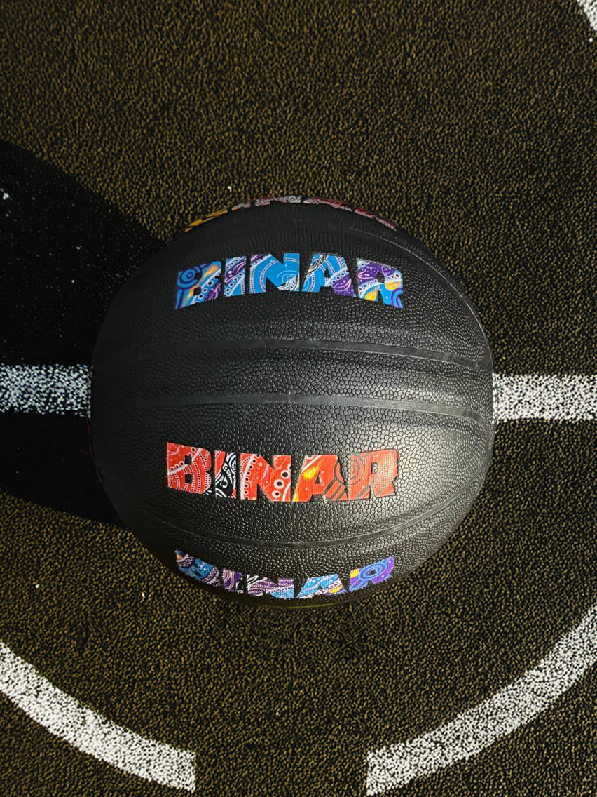 Black Binar basketball with colorful branding on a black surface with white lines